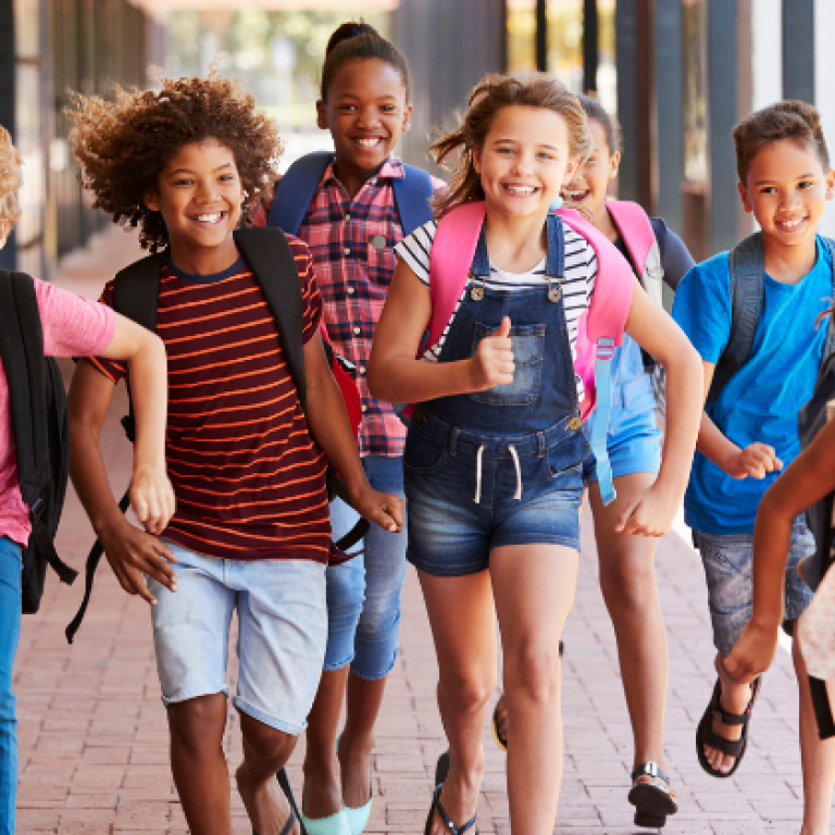 kids running happy together in school hall